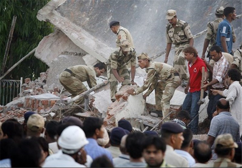 India Building Collapses Kill 8, Trap Dozen More