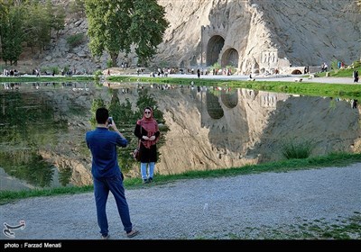 Visitors Tour Taq-Bostan Historical Site in Western Iran