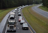 More than 1.5 million people were ordered to evacuate their homes in preparation. Vehicles lined up in heavy traffic (above) in Wallace, North Carolina on Tuesday