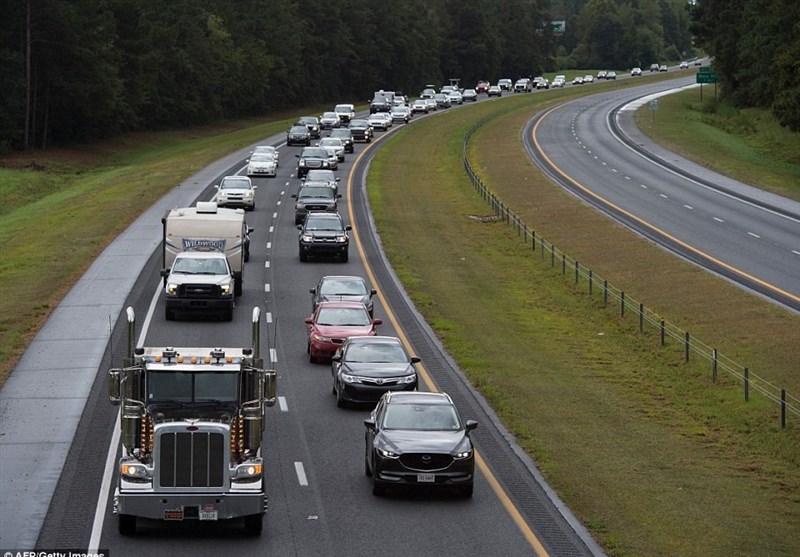 More than 1.5 million people were ordered to evacuate their homes in preparation. Vehicles lined up in heavy traffic (above) in Wallace, North Carolina on Tuesday