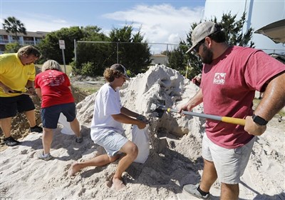 People fill sand bags in Isle of Palms, South Carolina on Monday as the state&apos;s entire coastline was ordered to prepare for mandatory evacuations