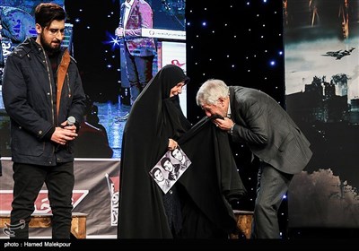 بوسه صادق آهنگران بر چادر مادر شهیدان خالقی‌پور در مراسم افتتاحیه نهمین جشنواره مردمی فیلم عمار