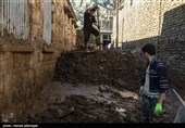 جهادگران بسیجی در حال خای کردن گل و لای خانه ها از سیل در روستای سیل زده معمولان پلدختر در لرستان
