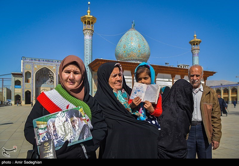 People posed for a picture outside of a polling station in Shiraz