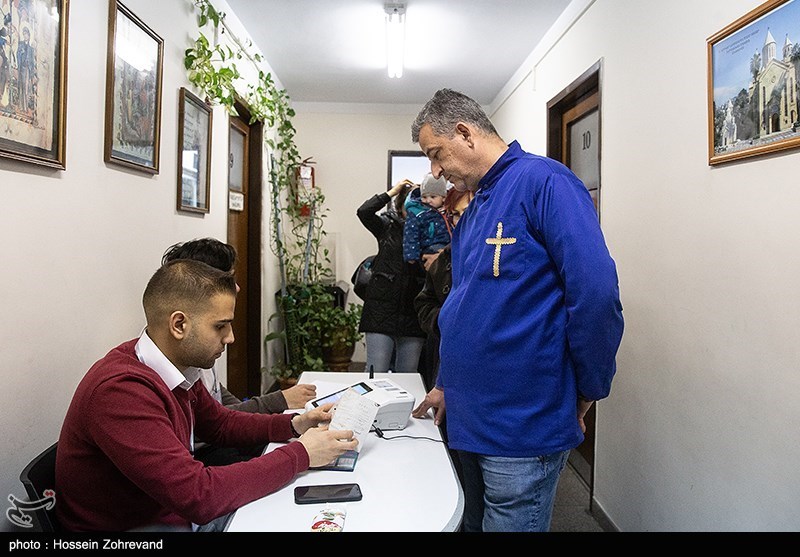 An Armenian Christian votes at a church in Tehran 