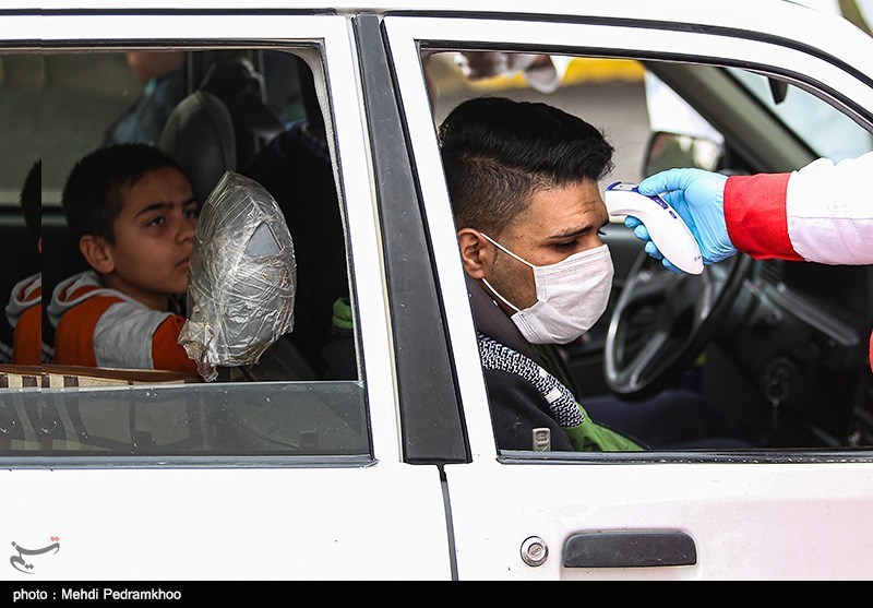 A Red Crescent worker took the temperature of a passenger in Ahwaz in western Iran on March 22.