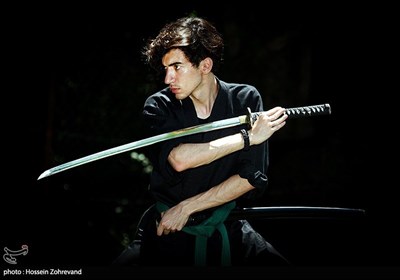 یکی از شرکت کنندگان در دوره ویژه و بین المللی زندگی در شرایط سخت و بقاء در طبیعت در حال کاتاناو استفاده از شمشیر ژاپنی سامورایی و نینجا است.