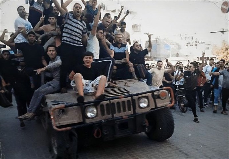 Palestinians in Gaza celebrate on a captured Israeli armored vehicle on October 7th, 2023. Photo: Nablus News Telegram 