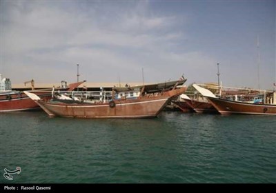 اهتزاز پرچم حرم رضوی به دست خدام در سواحل خلیج فارس بوشهر