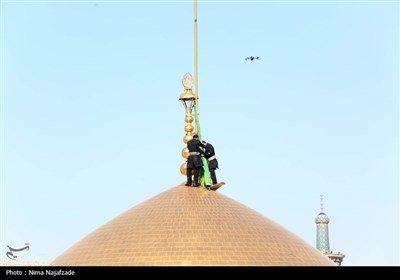 تعویض پرچم گنبد حرم مطهر رضوی به مناسبت میلاد امام رضا(ع)